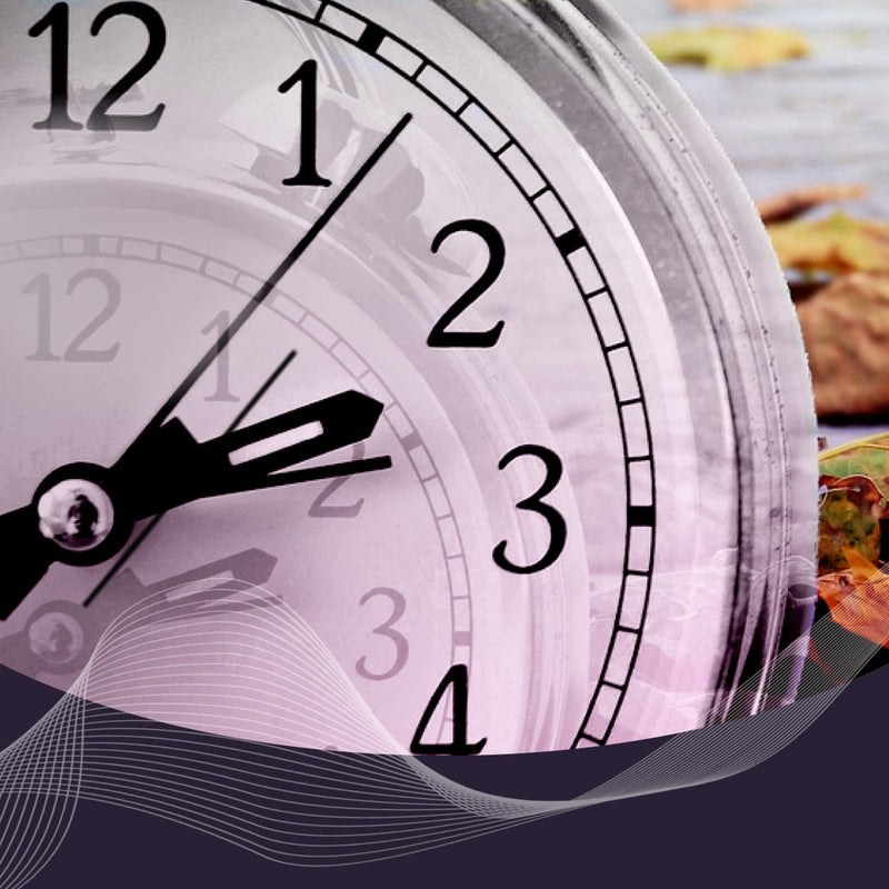 Close-up of an analog clock face over autumn leaves, evoking daylight saving time and shifted sleep patterns