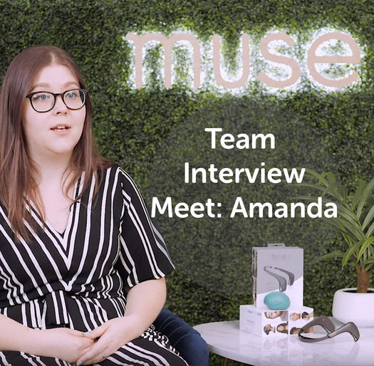 Amanda, product designer, seated by 'muse' sign with product box; on image text: Team Interview Meet: Amanda