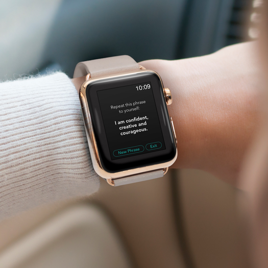 Apple Watch showing app screen reading 'Repeat this phrase to yourself:' 'I am confident, creative and courageous.' Time 10:09; buttons 'New Phrase' 'Exit'.