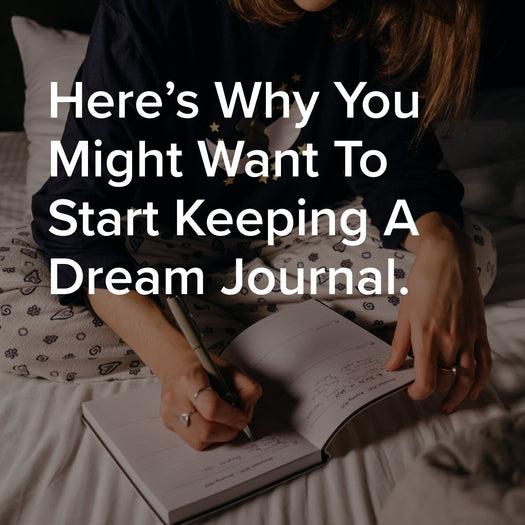 Here’s Why You Might Want To Start Keeping A Dream Journal. Woman writing in a notebook on a bed.