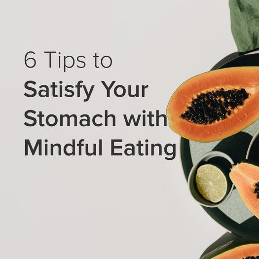 6 Tips to Satisfy Your Stomach with Mindful Eating — halved papaya and lime on dark plate